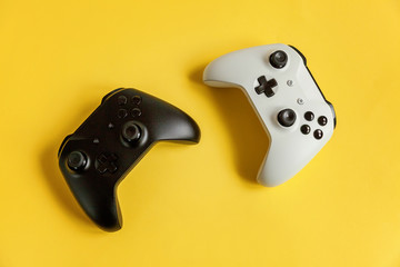 White and black two joystick gamepad game console on yellow colourful trendy modern fashion pin-up...