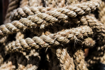 Close-up, an old twisted, tied, knotted rope