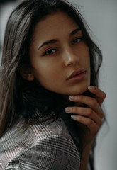 Fototapeta premium Portrait of a woman against grey background.