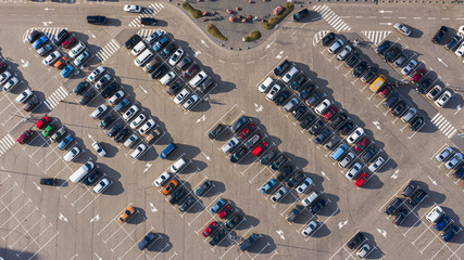Filled car parking near mall top view on sunny day photo from height