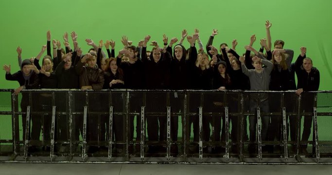 GREEN SCREEN CHROMA KEY Model released, Front view of huge crowd dancing and cheering at a concert or a show behind control barrier. Shot on RED Helium 8K Prores 4444