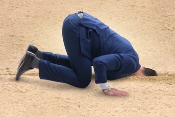 The businessman hiding his head in sand escaping from problems