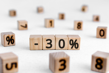 -30% - from wooden blocks with digits , -30% sale concept, white background random numbers around