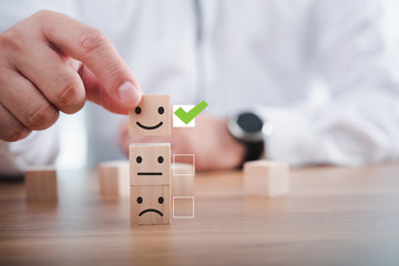 Businessman giving rating with happy icon, Customer satisfaction survey concept