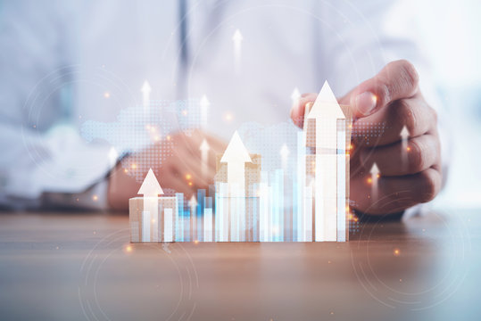 Business development to success and growing growth concept.businessman try to arrange wooden blocks into growing graphs.