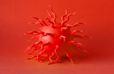 Fototapeta premium The red molecule of the virus on a red background. Selective focus. coronavirus nCoV 2019. Monocolor