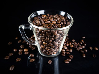 coffee beans in the glass on black background