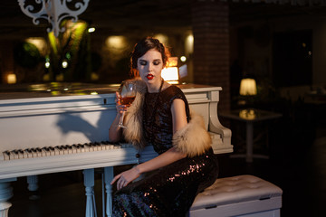 Portrait of 20s style festive beauty in a restaurant