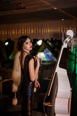 Portrait of 20s style festive beauty in a restaurant