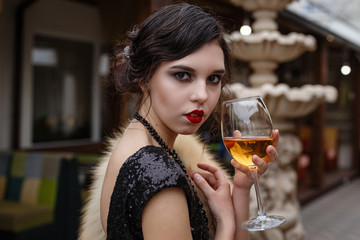 Portrait of 20s style festive beauty in a restaurant