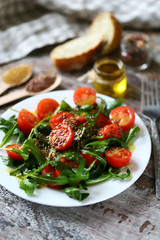 Healthy salad with arugula, cherry tomatoes and seeds. Diet concept.
