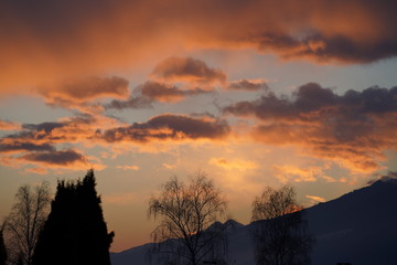 beautiful orange sky with clouds and mountain silhouette in the morning 
