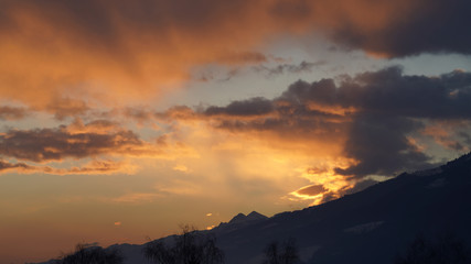 beautiful orange sky with clouds and mountain silhouette in the morning 