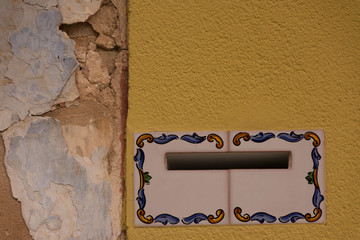 Mailbox slot in a house wall