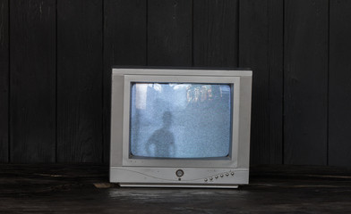 old tv on black wooden background