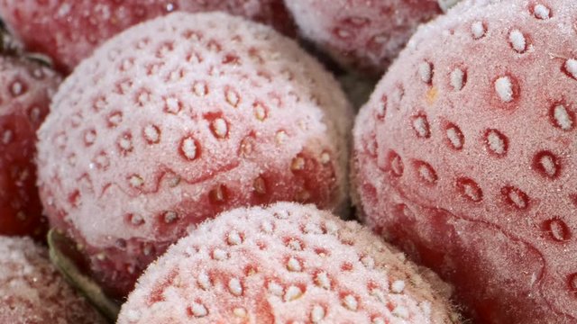 Extreme closeup of fresh frozen strawberries, Rotation 360 degrees, Close-up