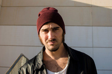 young man with goatee looks defiant