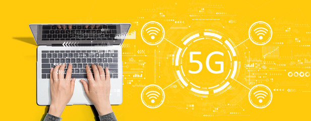 5G network with person using a laptop computer