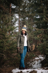 Young lady standing between trees with snow