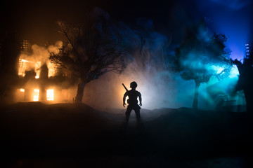 Naklejka na ściany i meble War Concept. Military silhouettes fighting scene on war fog sky background, World War Soldiers Silhouette Below Cloudy Skyline At night.