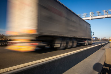 Truck passing through a toll gate on a highway, highway charges, motion blurred image