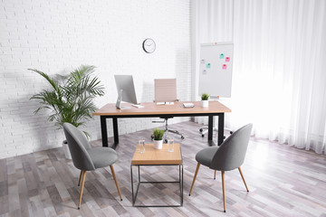 Interior of modern office with table, chairs and computer