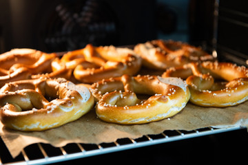 Obraz na płótnie Canvas Closeup photo of handmade lye bun and pretzel in bakery