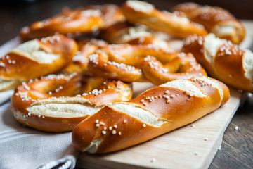 Closeup photo of handmade lye bun and pretzel in bakery