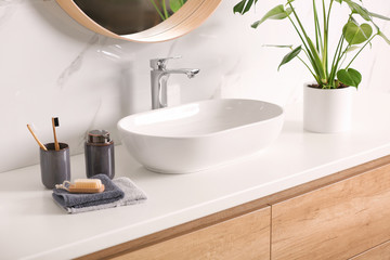 Fototapeta na wymiar Stylish vessel sink on light countertop in modern bathroom
