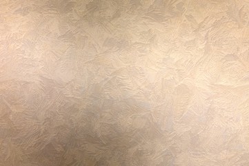 Decorative plaster beige textured background. Strokes of stucco pattern.