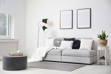 Stylish living room interior with comfortable sofa