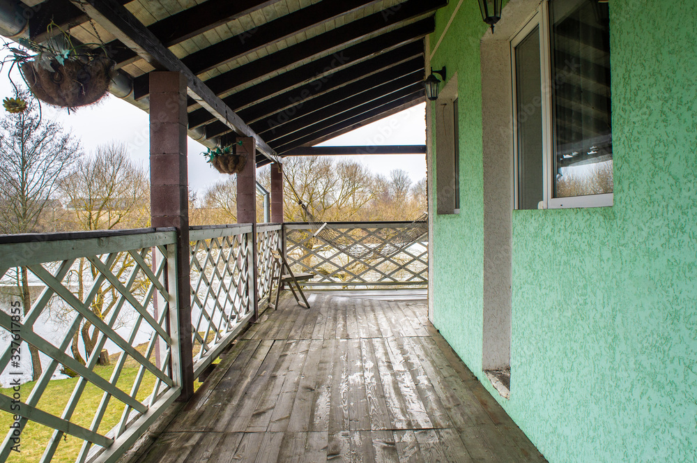 Wall mural beautiful wooden villa with a green patio. minsk, belarus - march 01 2020