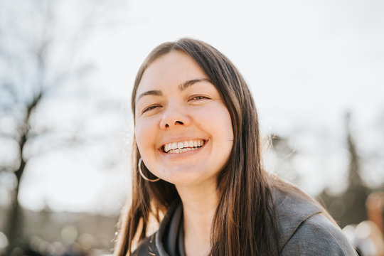 Close Up Portrait Of Attractive 40 Years Old Woman Looking At Camera Smiling With Toothy Smile Outdoors. No Makeup, Natural Beauty.