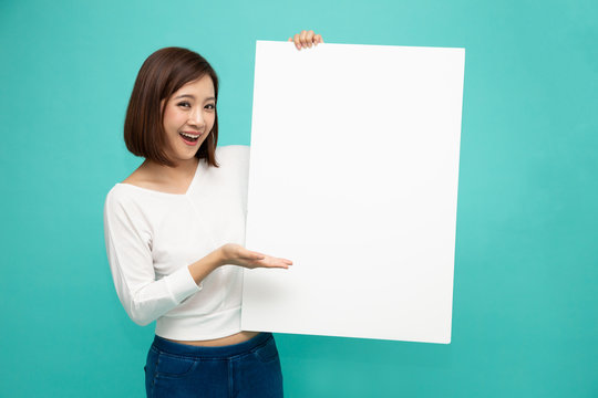 Young attractive asian woman showing and holding blank white board, Showing empty board for input your text