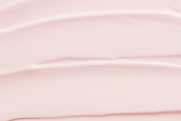Beauty cream lotion moisturizer texture background. Pink color cosmetic cream smear smudge....