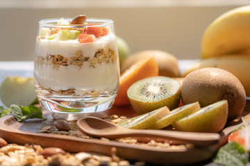 Plain yogurt with fresh fruits and granola on top in glass.Healthy food