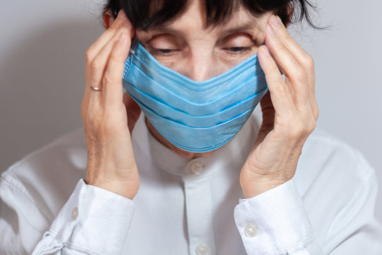 Coronavirus quarantine and Air pollution pm2.5 concept. Sick sad depressed, thoughtful old woman wearing respirator mask for protect. Wuhan, China epidemic virus symptoms background.