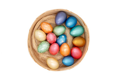 Obraz na płótnie Canvas color easter eggs in basket isolated on white