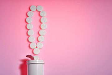 Pharmaceutical.The exclamation mark of the pills.Exclamation point. White pills on a pink background. Important information on medical topics. Copy space.