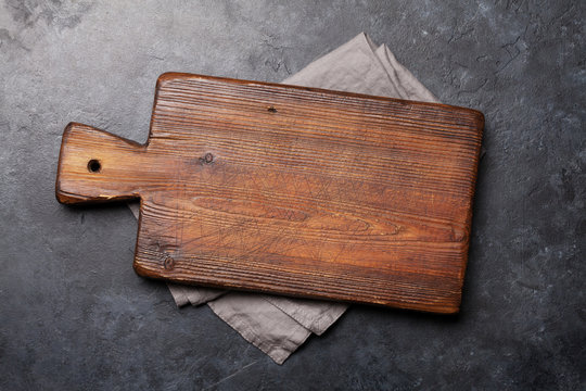 Cutting board over towel on stone kitchen table