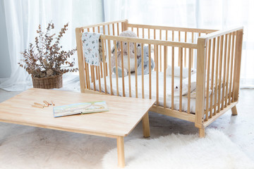 baby wood bed and table with mattress kid pillow dolls - obrazy, fototapety, plakaty