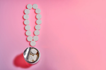 Pharmaceutical.The exclamation mark of the pills.Exclamation point. White pills on a pink background. Important information on medical topics. Copy space. Medicine and healthy concept.
