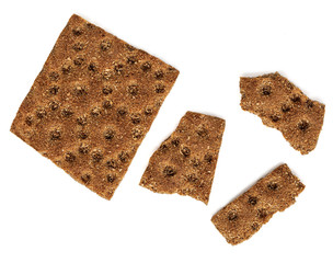 Rye crispy crackers  isolated on white background. Crushed dry wholegrain cracker pieces or flat bread. Top view