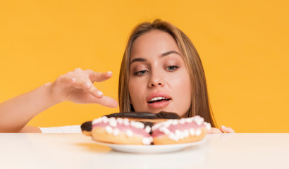 Hungry Girl Taking Sweets From Plate, Fancy About Unhealthy Junk Food