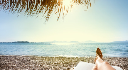 woman feet in sunbed on the beach