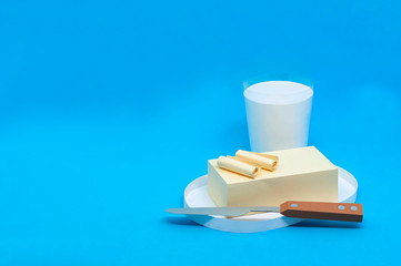 Paper butter on plate and milk in glass