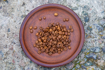 coffee beans on a brown clay plate