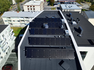 Aerial view of solar panels on the roof of the apartment building.