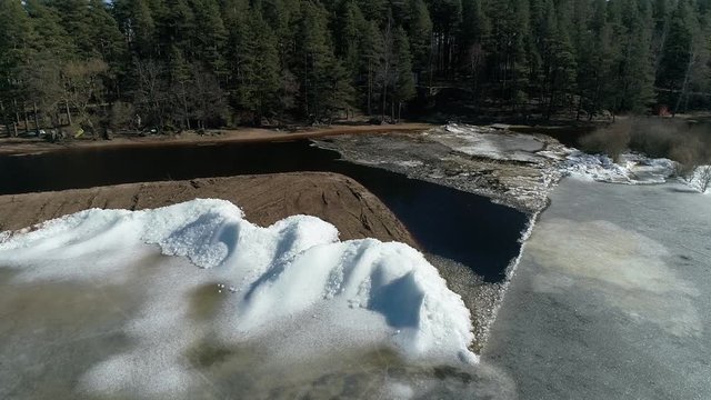 Moving ice plates in spring on lake Burtnieks ice shove aerial view