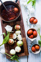 Dyeing eggs for Easter holidays, coloring with different color and tonality using natural food dye pigment and painting color, over a white  background, chocolate eggs , top view, flatlay,soft light